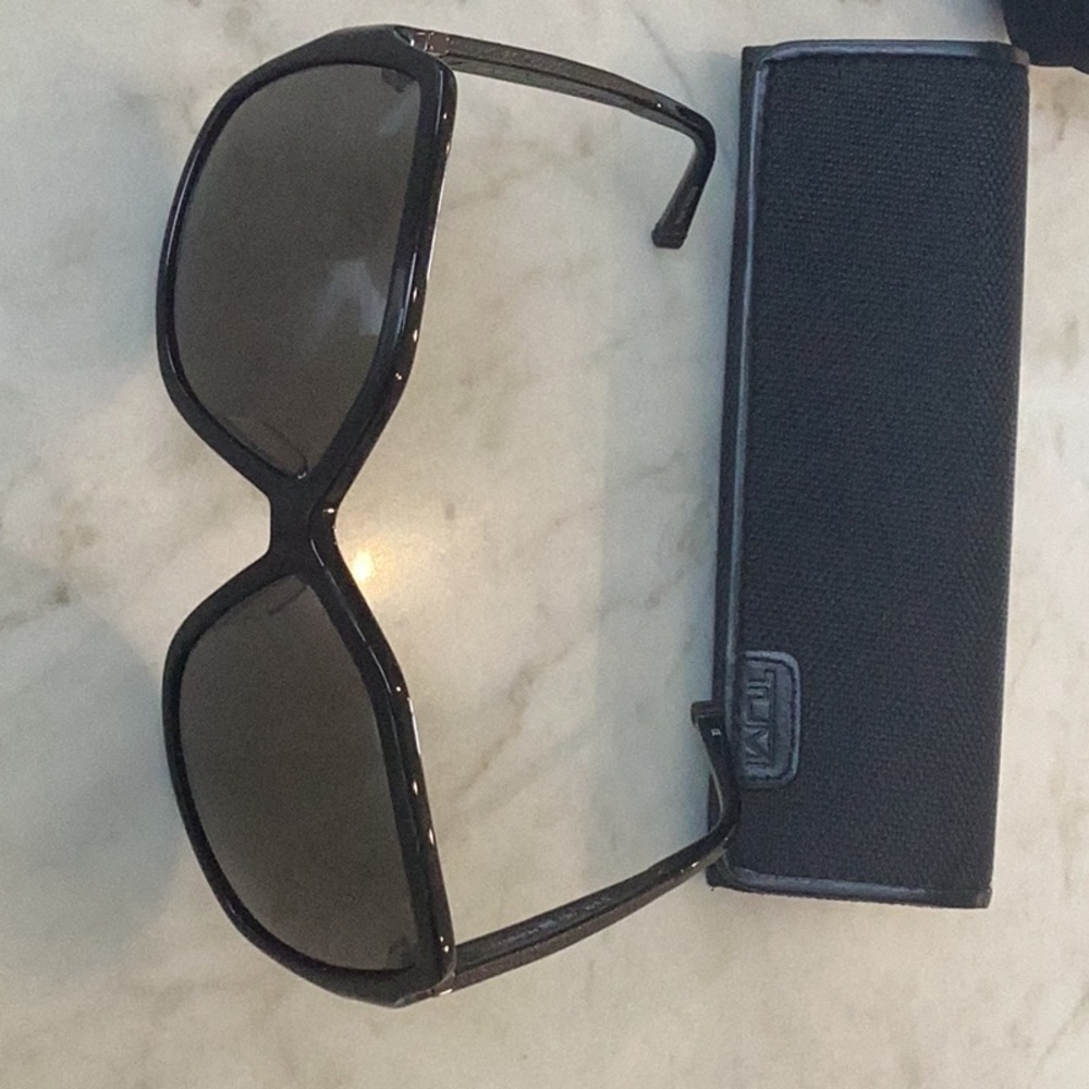 Brand new Tumi brand sunglasses .Never worn. Black leather trim Polarized lenses
